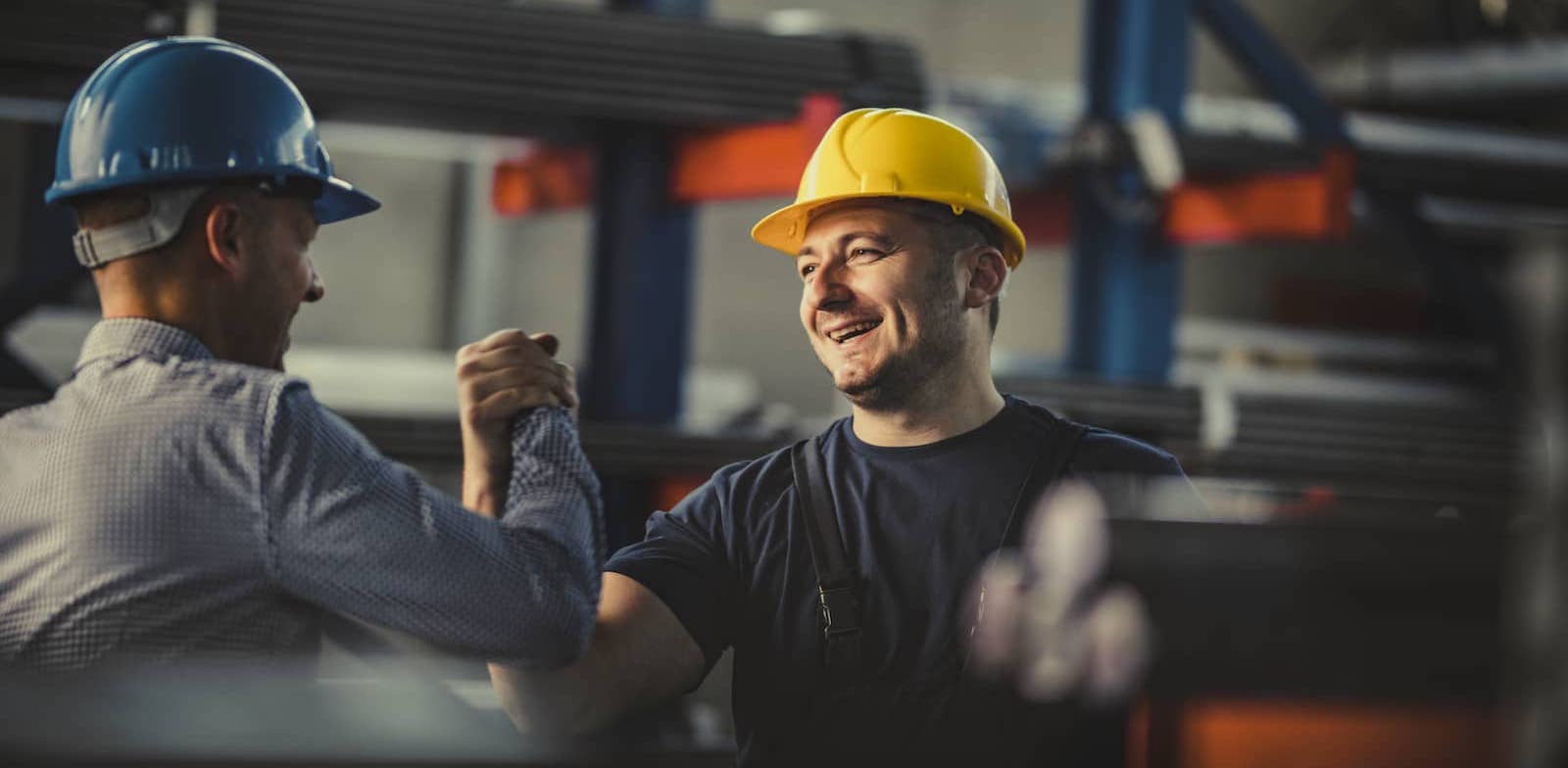 two construction workers excited and giving high fives
